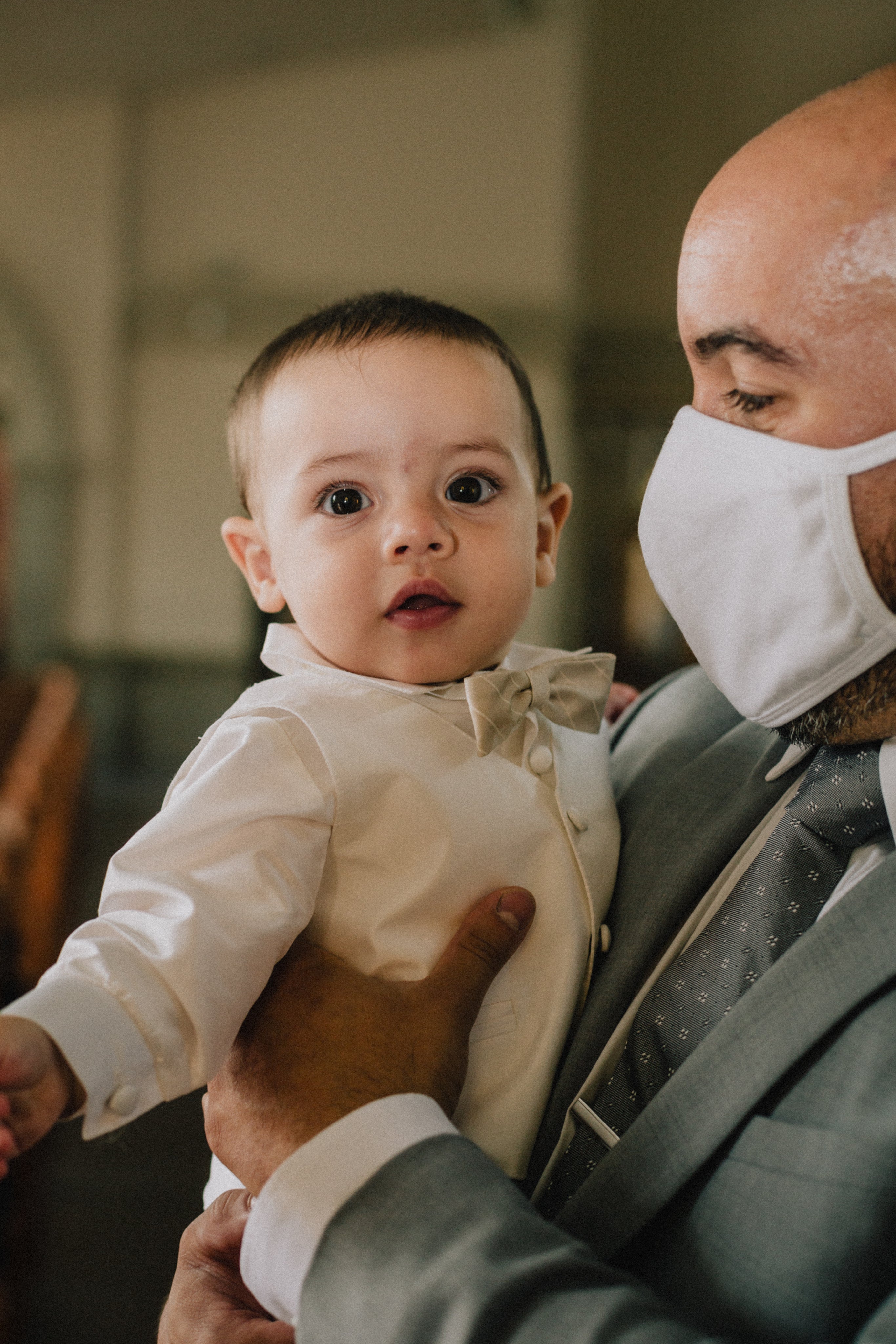 files/person-in-grey-suit-and-facemask-holds-a-young-baby.jpg
